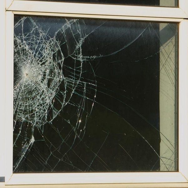 Shattered window showing vulnerability before installing security window film.