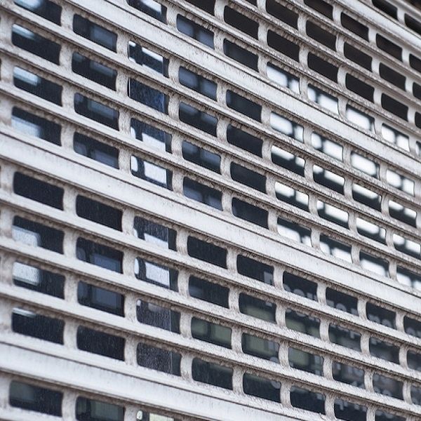 Close-up of a roll-down metal security grille protecting a storefront window