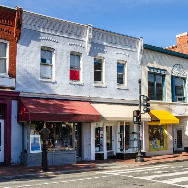 Row of classic brick storefronts in a commercial area, highlighting the need for forced entry resistant doors to enhance commercial security.