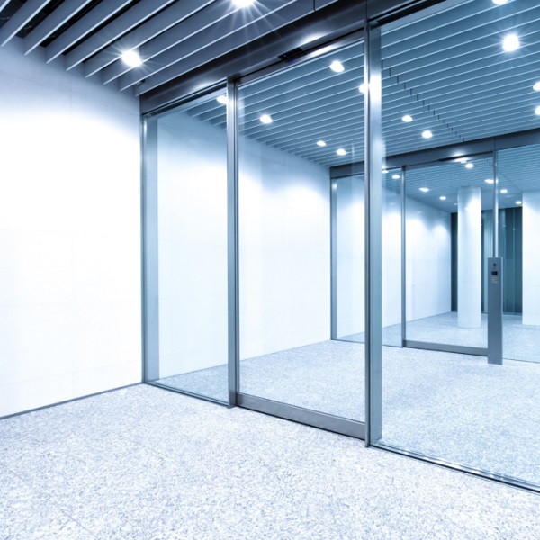 Touchless access control trend for 2025 showing automatic commercial security doors using proximity sensor technology.