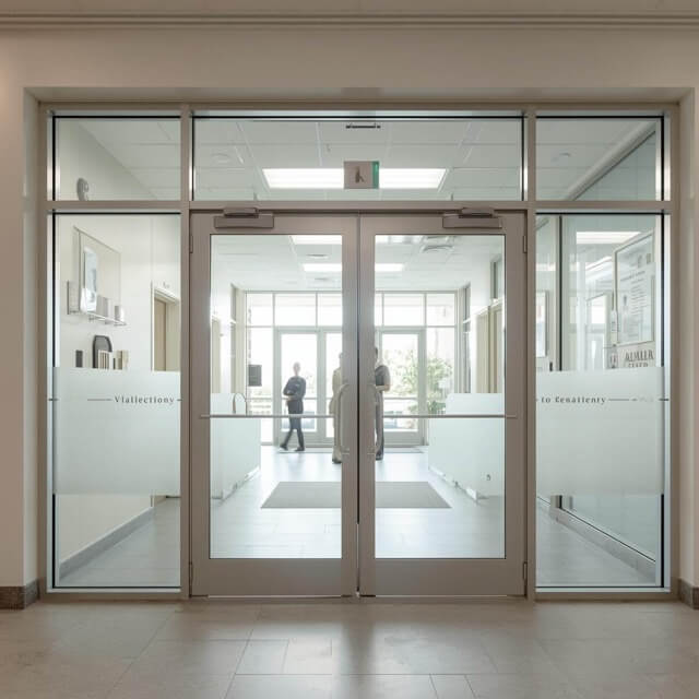 Sliding glass doors with retrofit security glazing.